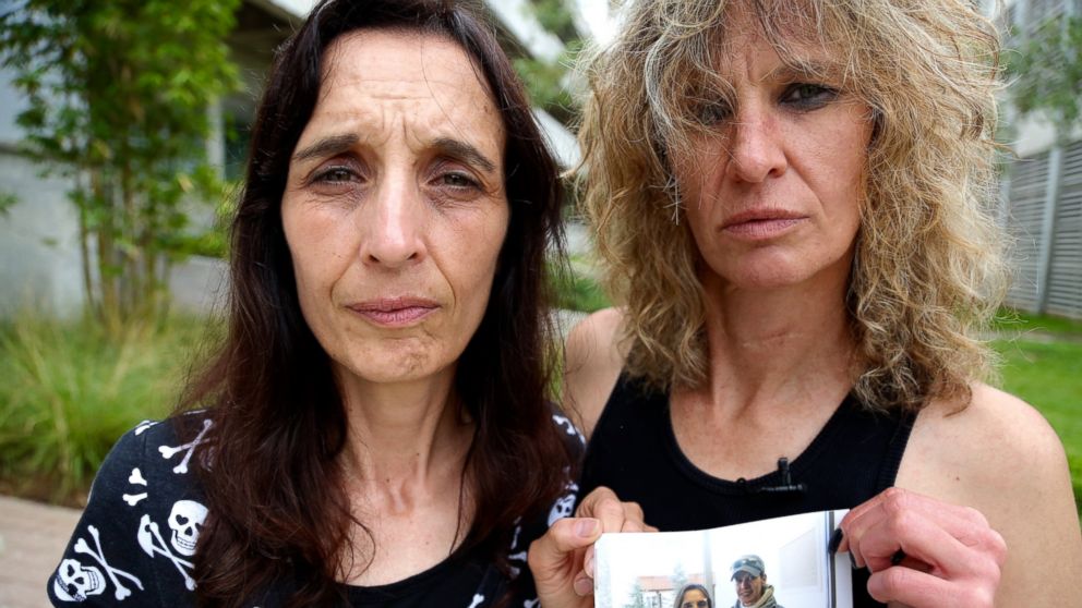 Leigh Erceg, right, and her friend Amber Anastasio, left, are shown here holding a picture of the two of them taken before Erceg's accident.