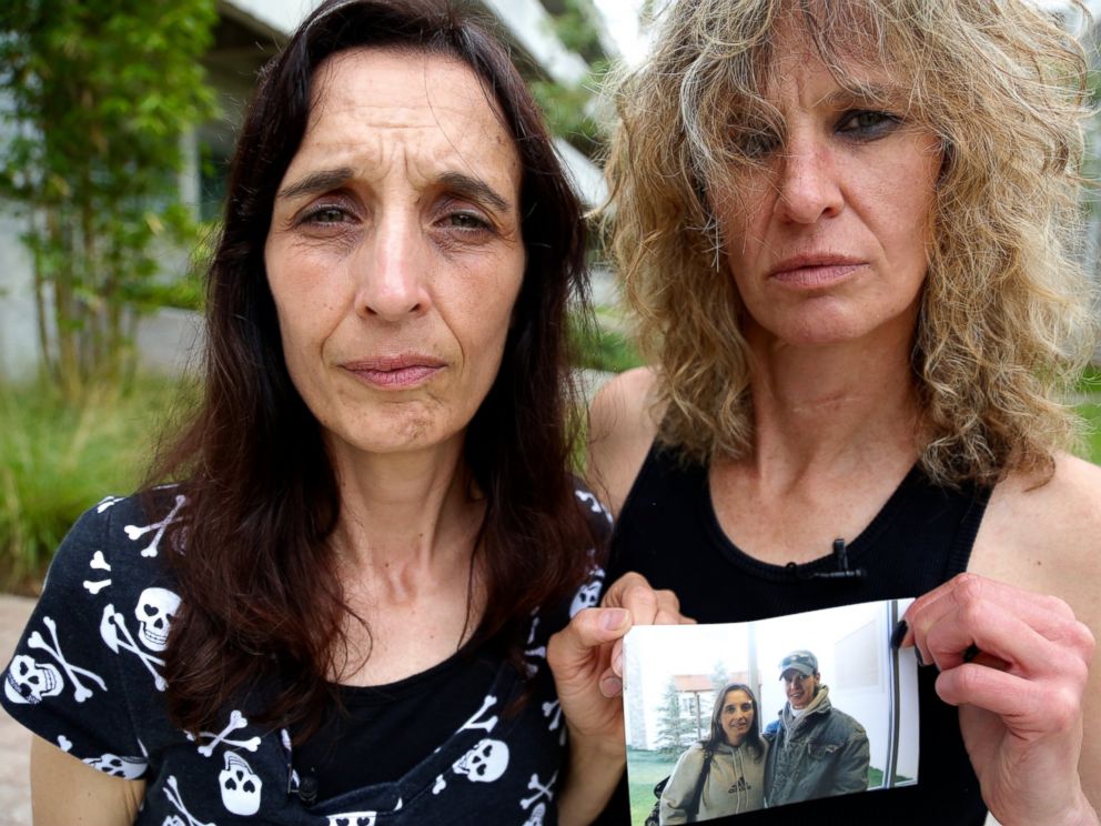 Leigh Erceg, right, and her friend Amber Anastasio, left, are shown here holding a picture of the two of them taken before Ercegs accident.