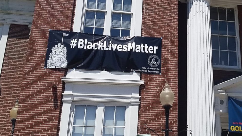 A Black Lives Matter banner affixed to the front of Somerville's City Hall building has caused controversy in this blue collar suburb of Boston after a local police union president asked that it be replaced. 
