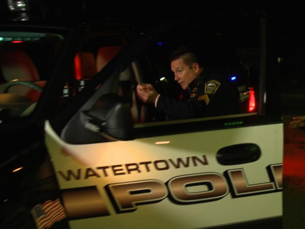 PHOTO: Watertown police officer John MacLellan reenacts part of his shootout with the Boston Marathon bombers, three days after the blasts in 2013.
