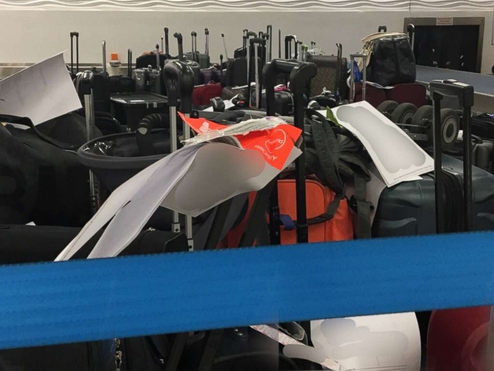 Bags piled up at the Charlotte Douglas International Airport in Charlotte, North Carolina, after hundreds of flights were canceled.