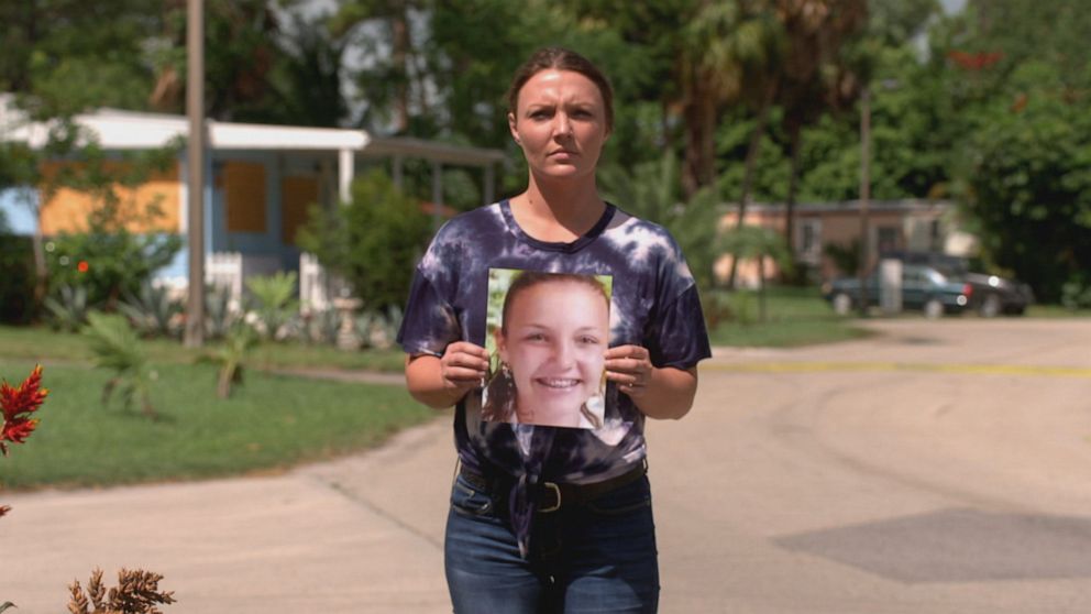 PHOTO: Courtney Wild is seen here holding a photo of her younger self.