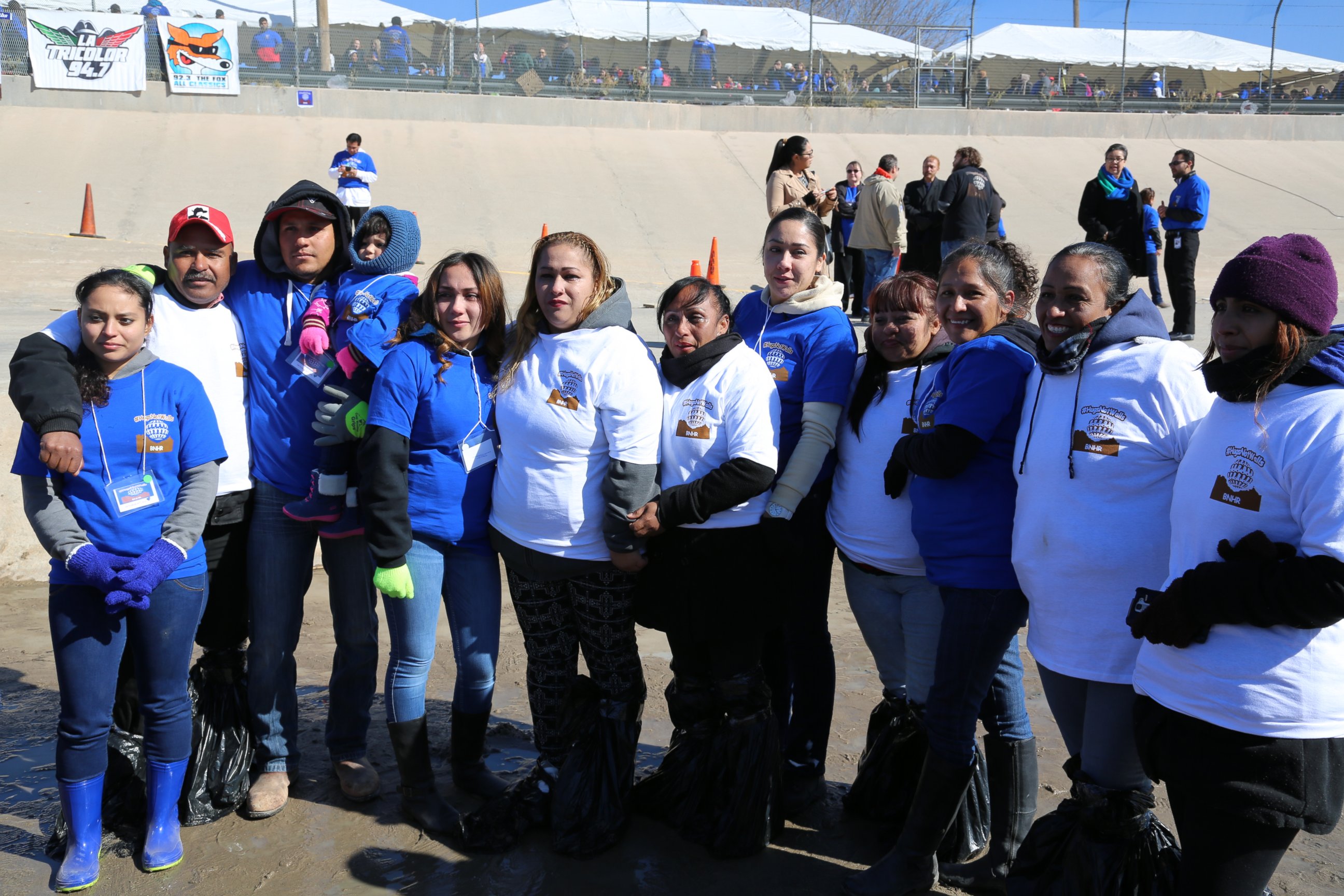 "Debora" and her reunited family are pictured here at the "Hugs Not Walls" event.