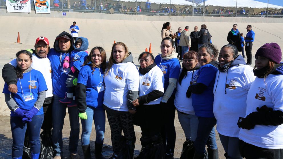 "Debora" and her reunited family are pictured here at the "Hugs Not Walls" event.