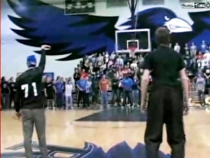 VIDEO: A blindfolded basketball coach sinks a half-court shot as part of a team bet.