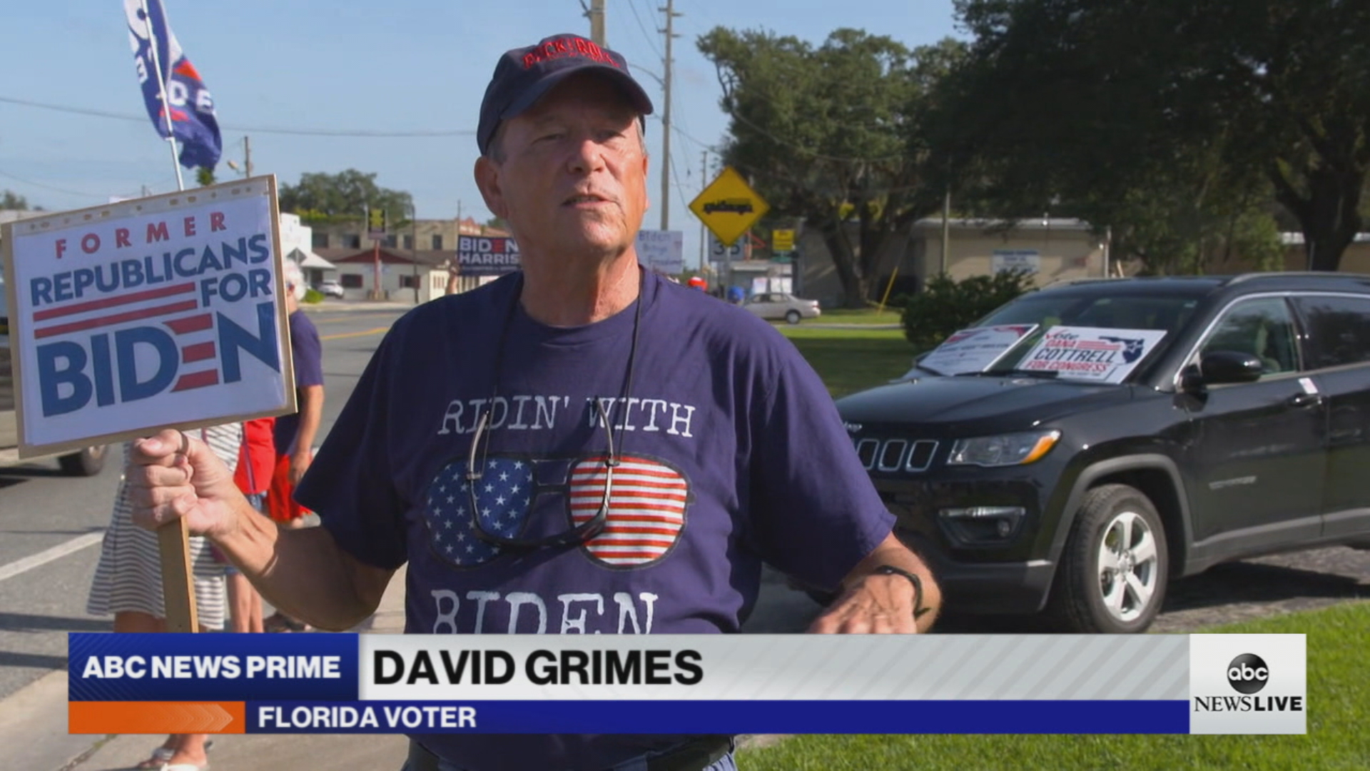 David Grimes is seen here with a "Former Republicans for Biden" sign.
