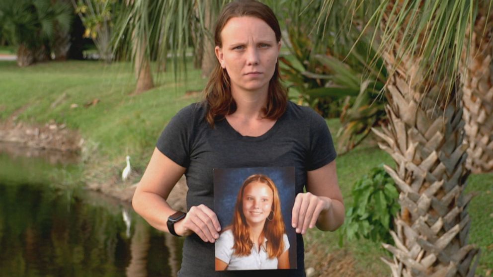Jena-Lisa Jones holds a photo of her younger self.