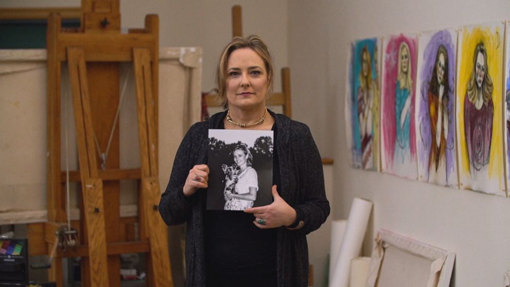 Maria Farmer is seen here holding a photo of her younger self during an ABC News interview.