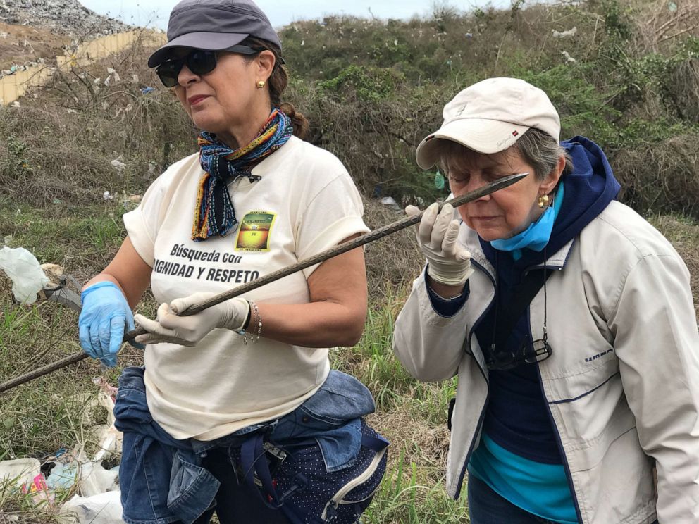 Lucy Diaz and other mothers poke the loose earth with a long metal construction rod and then smell the end of it to try to detect a dead body.