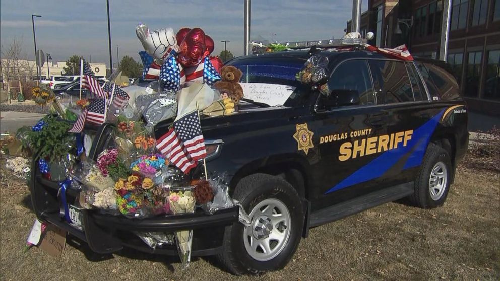 Mourners decorated Deputy Zack Parrish's police vehicle after he was killed. 