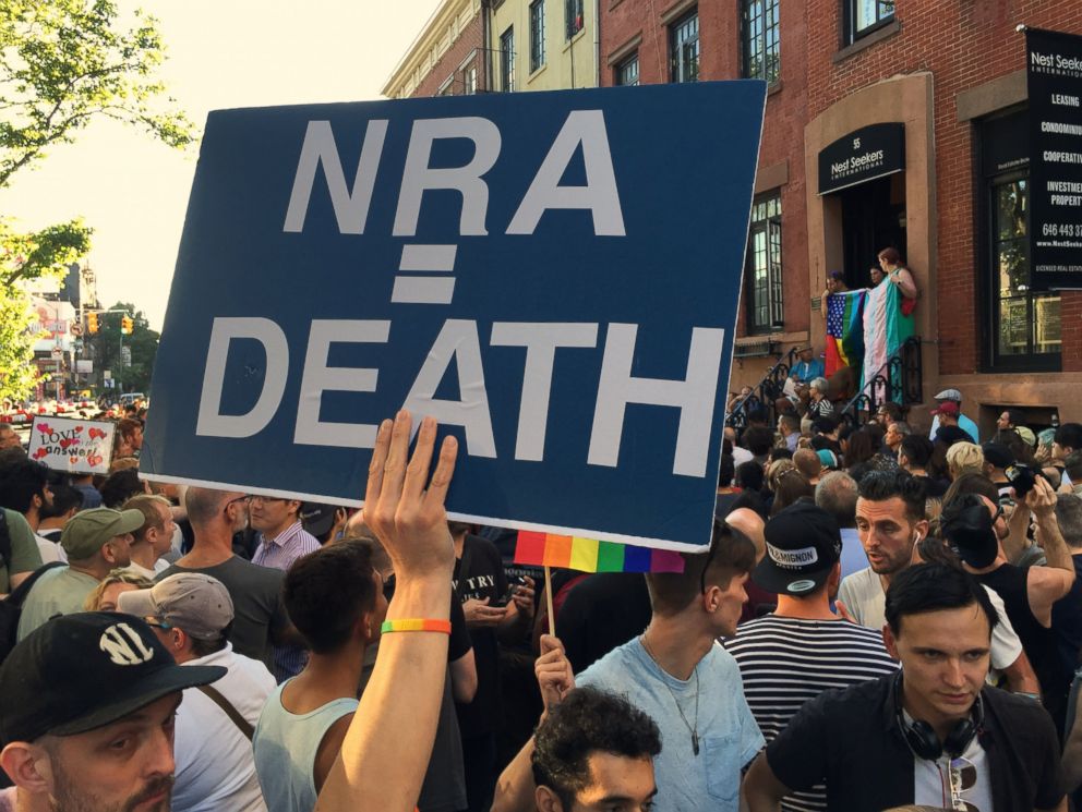 PHOTO: A person holds a sign that reads, "NRA=DEATH" at the Stonewall Inn in New York, June 12, 2016, during a vigil for the victims of a mass shooting in Orlando, Florida.