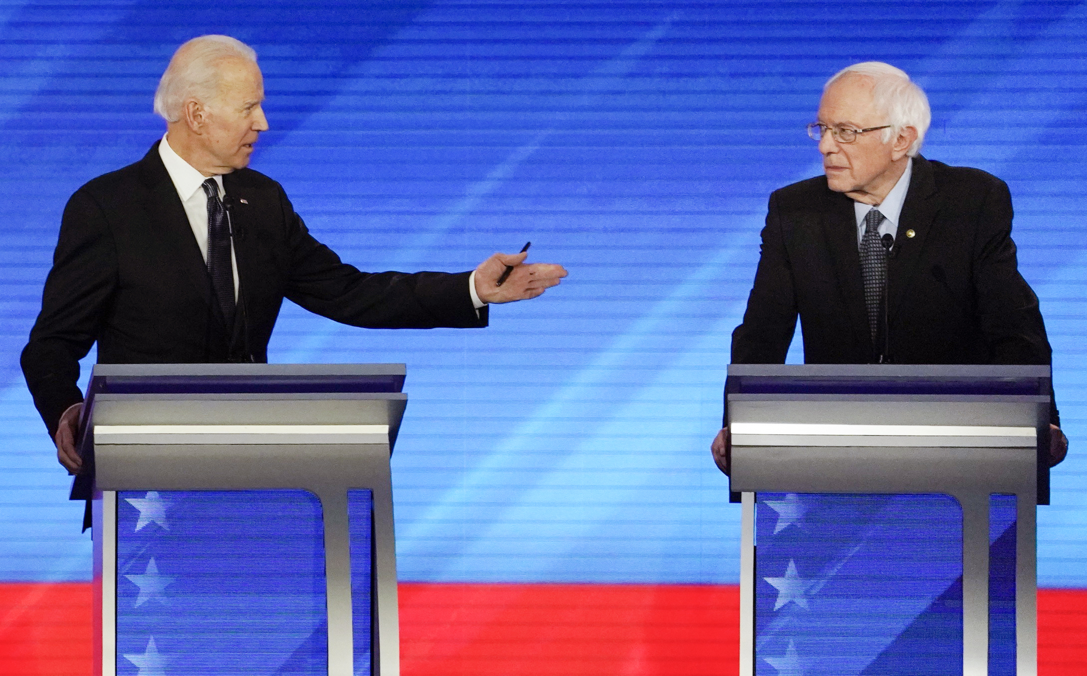 PHOTO: Democratic 2020 U.S. presidential candidate and former Vice President Joe Biden gestures towards Senator Bernie Sanders during the eighth Democratic 2020 presidential debate at Saint Anselm College in Manchester, New Hampshire, February 7, 2020.