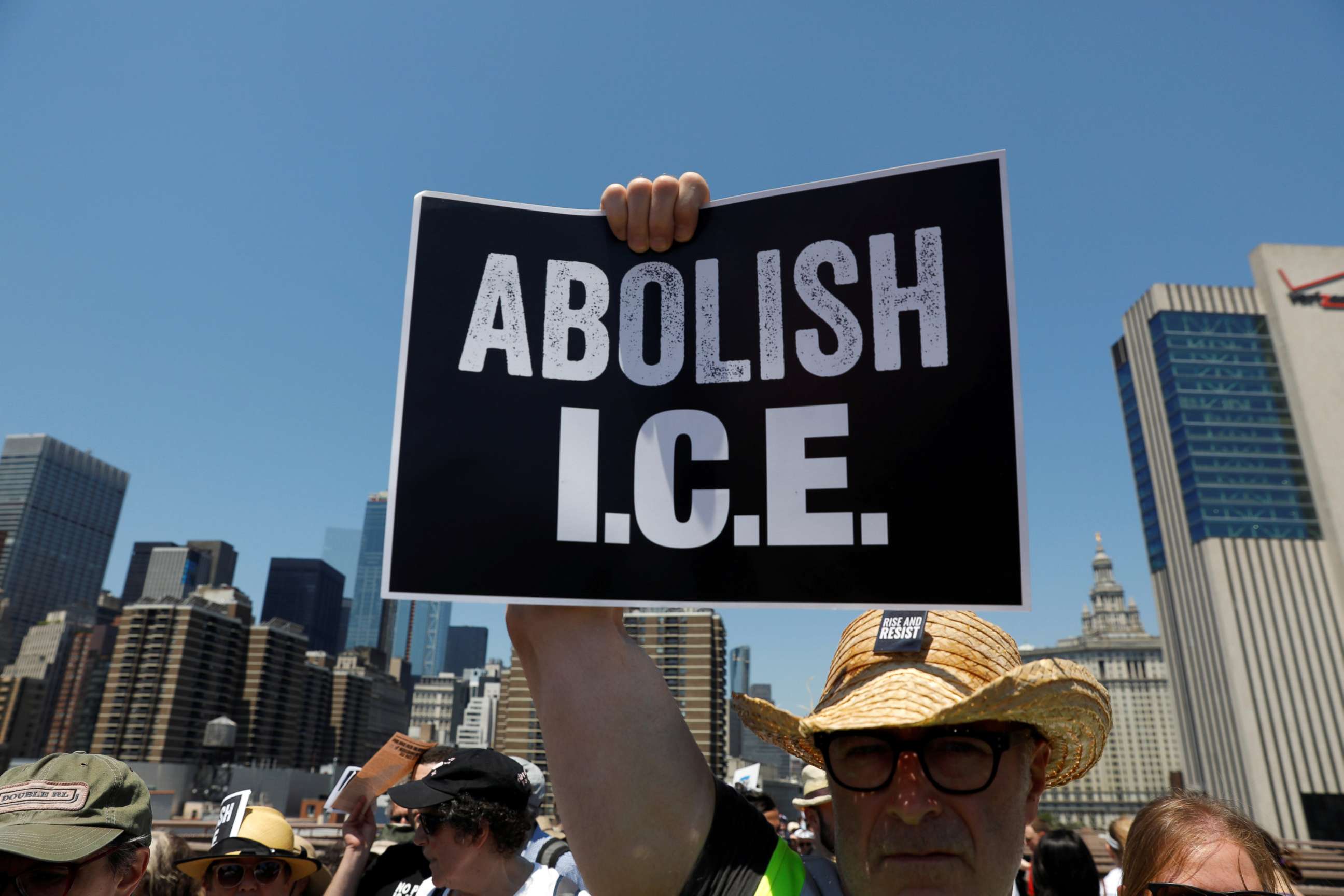PHOTO: A protest image is carried by a demonstrator as people cross the Brooklyn Bridge during "Keep Families Together" march to protest Trump administration's immigration policy in New York, June 30, 2018.