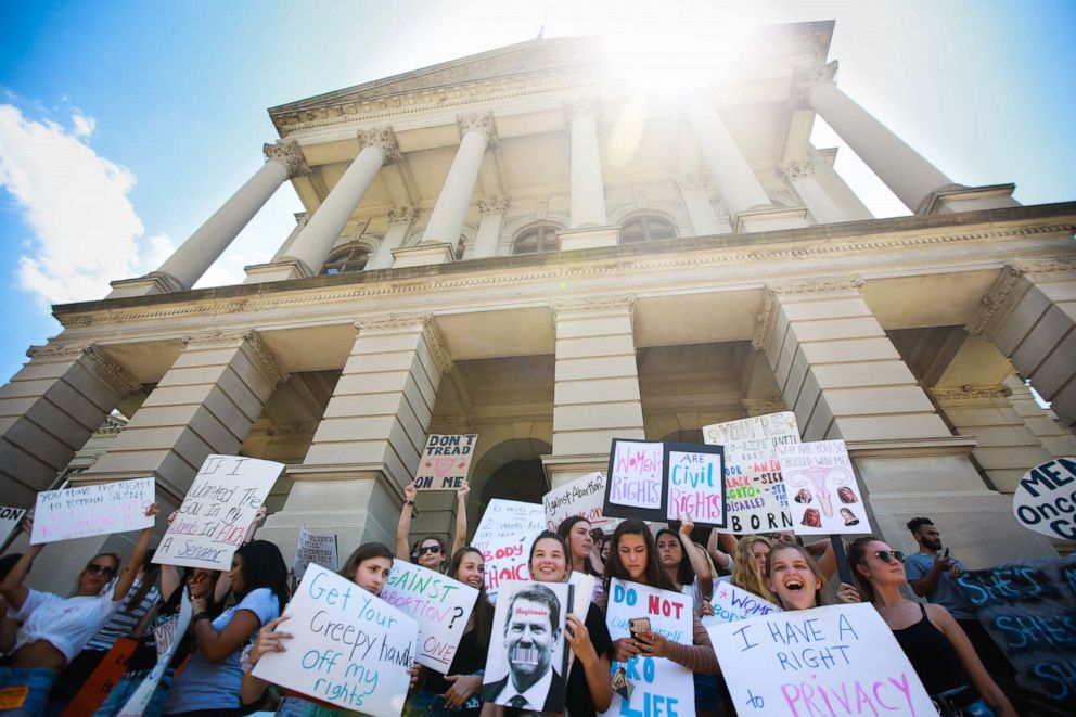 PHOTO: Women from Paideia High School hold signs during a protest against recently passed abortion ban bills at the Georgia State Capitol building, May 21, 2019, in Atlanta.