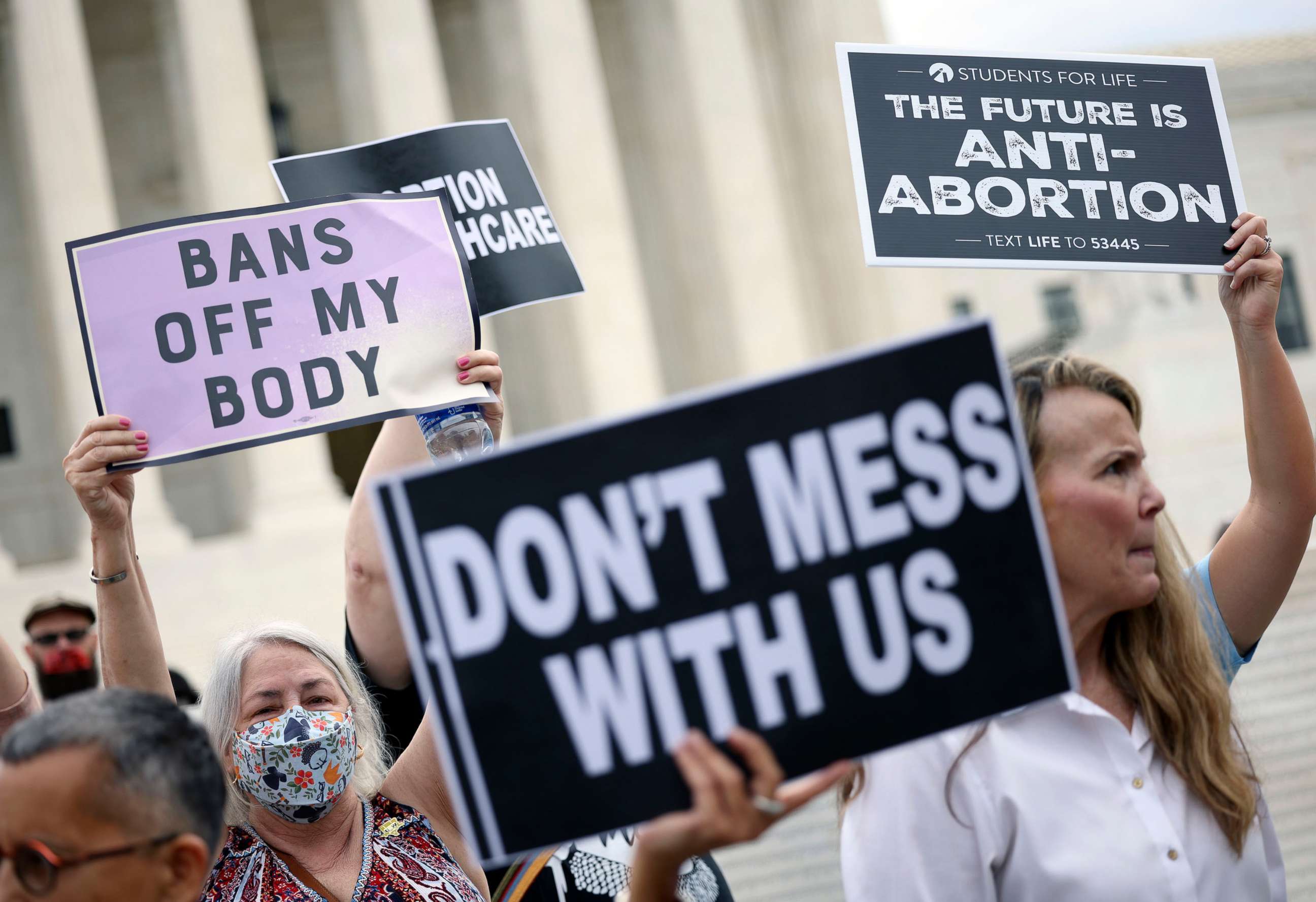 PHOTO: Pro-choice and anti-abortion activists protest alongside each other during a demonstration outside of the Supreme Court in Washington, Oct. 04, 2021.