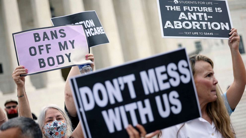 PHOTO: Pro-choice and anti-abortion activists protest alongside each other during a demonstration outside of the Supreme Court in Washington, Oct. 04, 2021.