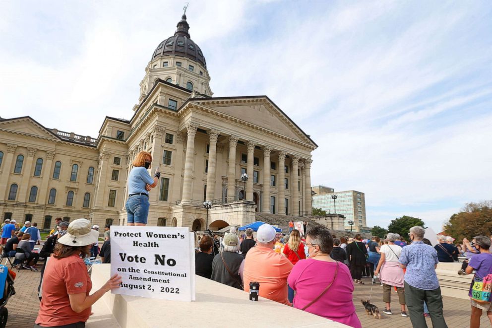 PHOTO: A women holds a sign asking voters to vote no on an upcoming amendment to the Kansas Constitution regarding abortion during Saturday's National Women's March in Topeka, Oct. 2, 2021.