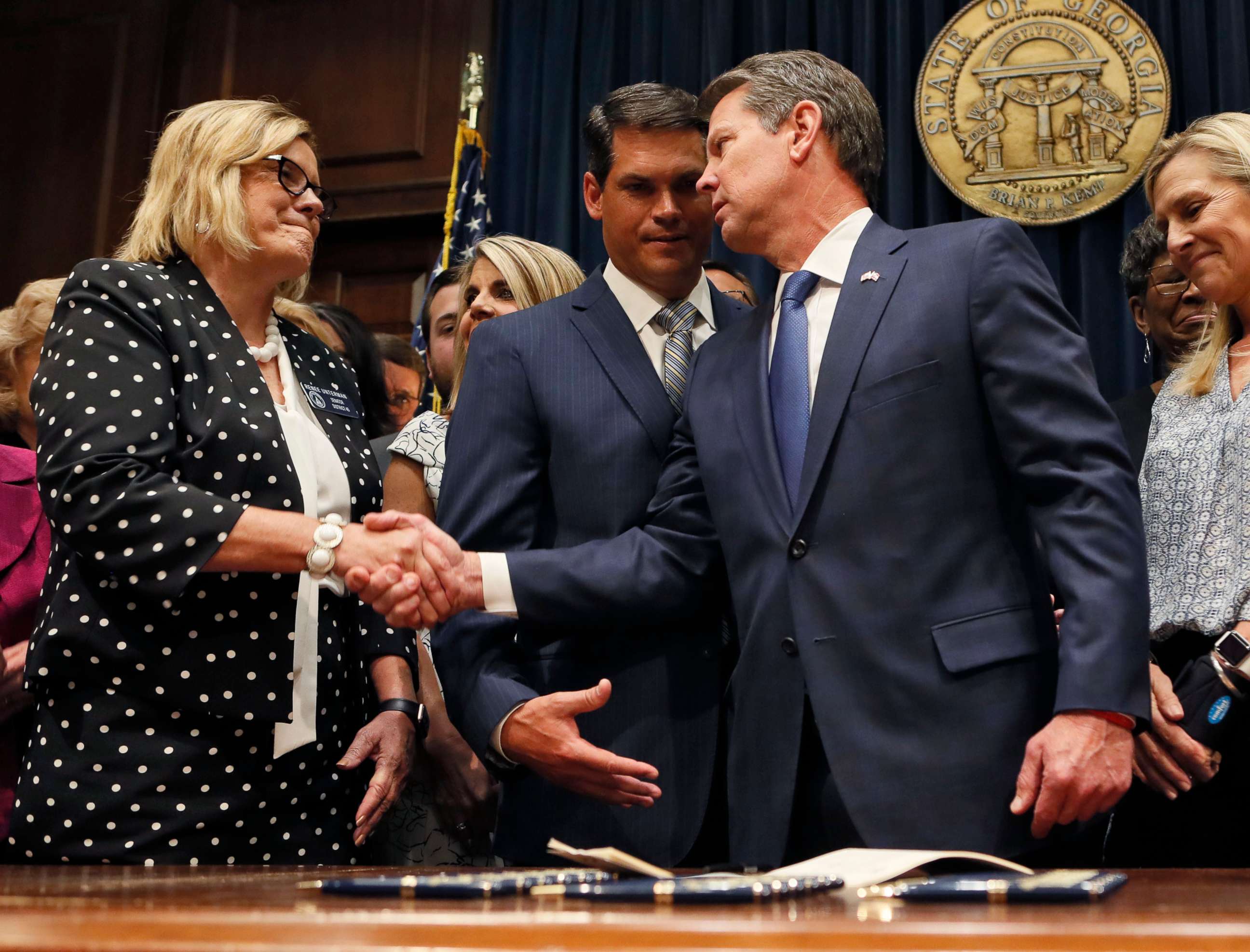 PHOTO: Georgia Gov. Brian Kemp shakes hands with state Sen. Renee Unterman after signing legislation banning abortions once a fetal heartbeat can be detected, in Atlanta, May 7, 2019.