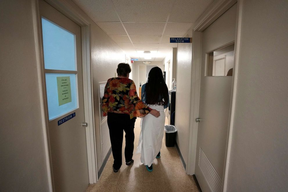 PHOTO: A 33-year-old mother of three from central Texas is escorted down the hall by clinic administrator Kathaleen Pittman prior to getting an abortion, Oct. 9, 2021, at Hope Medical Group for Women in Shreveport, La.
