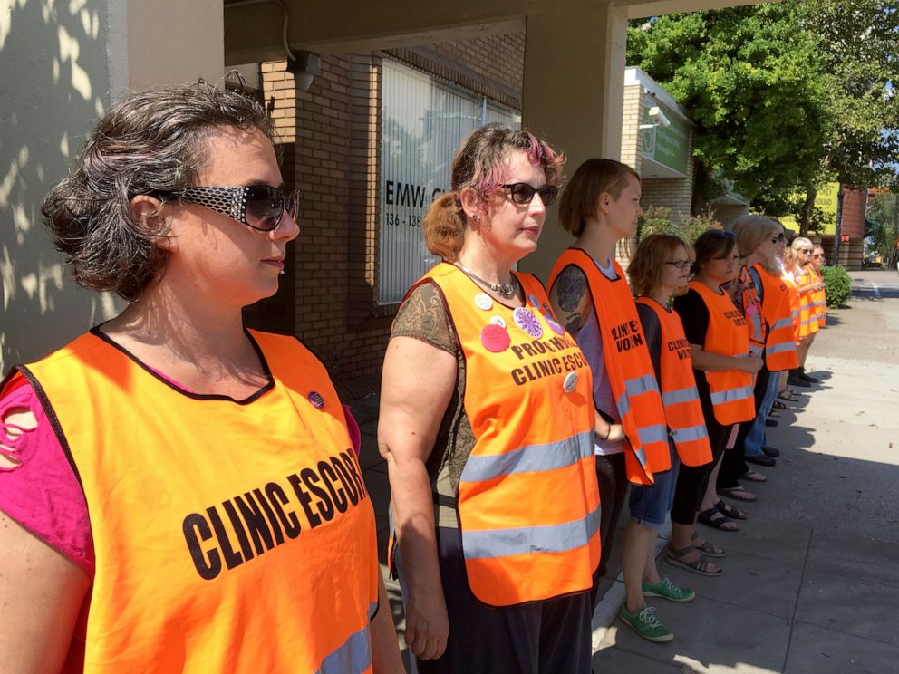 PHOTO: Escort volunteers line up outside the EMW Womens Surgical Center in Louisville, Ky., July 17, 2017. 