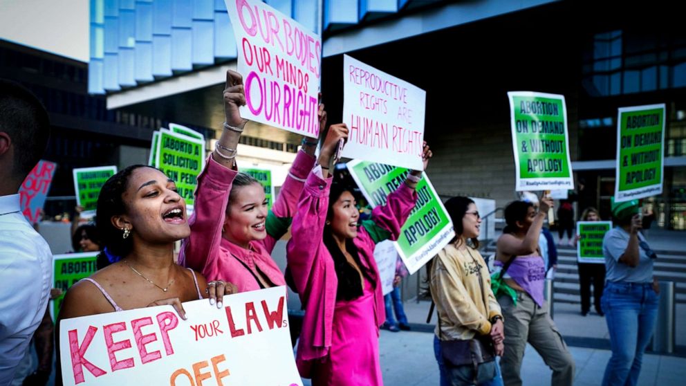 PHOTO: A group of young women hold signs during an abortion-rights rally in front of the Federal Courthouse in downtown Los Angeles on May 3, 2022.