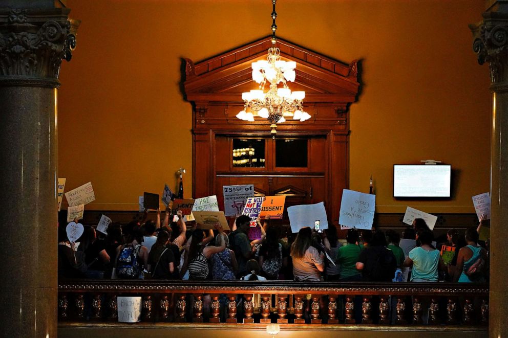 PHOTO: Activists protest outside the senate chambers in the Indiana Statehouse during a special session debating on banning abortion in Indianapolis, July 25, 2022.