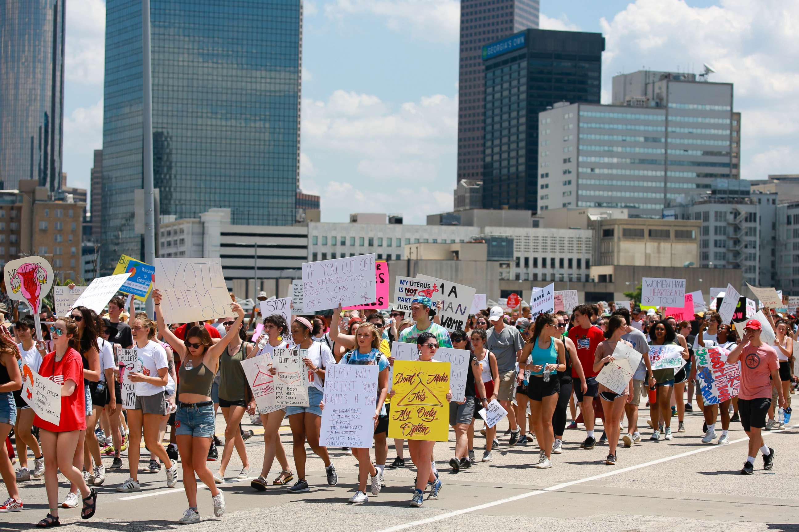PHOTO: Demonstrators hold signs while marching during a protest against Georgia's "heartbeat" abortion bill in Atlanta, May 25, 2019.