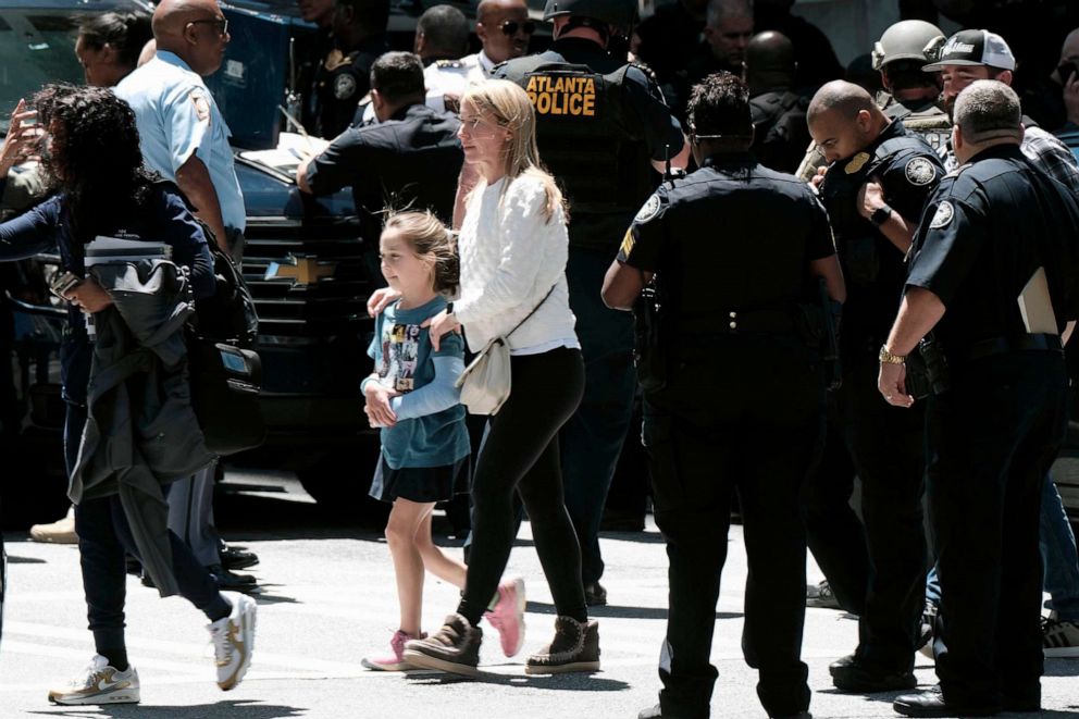 PHOTO: People stand outside a commercial building after a shooting, May 3, 2023, in Atlanta.