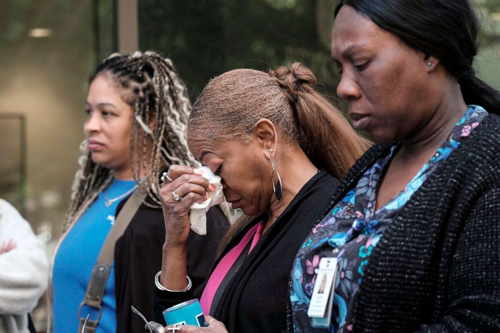 PHOTO: People stand outside a commercial building after a shooting, May 3, 2023, in Atlanta.