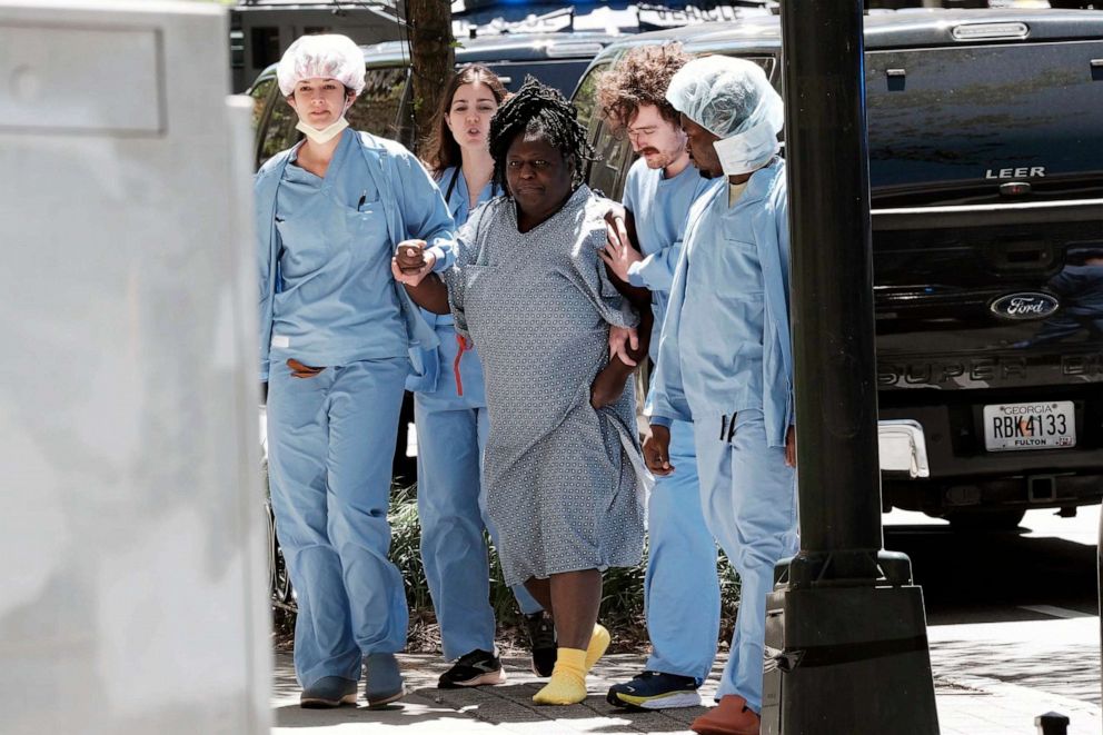 PHOTO: A medical patient is helped away from the scene of an active shooter, May 3, 2023 in Atlanta.