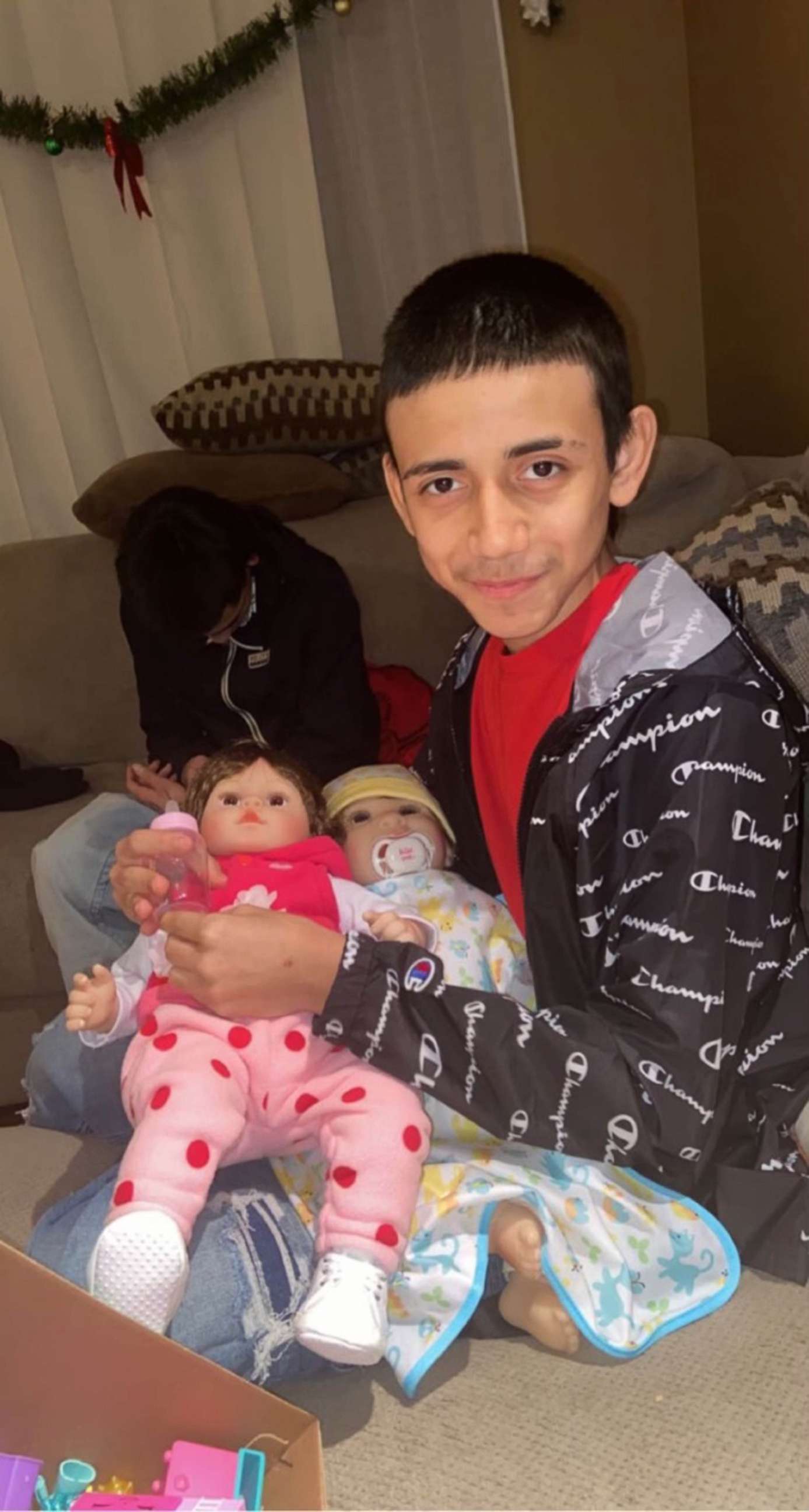PHOTO: Adam Toledo is pictured with his cousin's 7-year-old daughter Kaylah's dolls, Jan. 1, 2021. Adam would play with them to make Kaylah laugh, his cousin told ABC News.