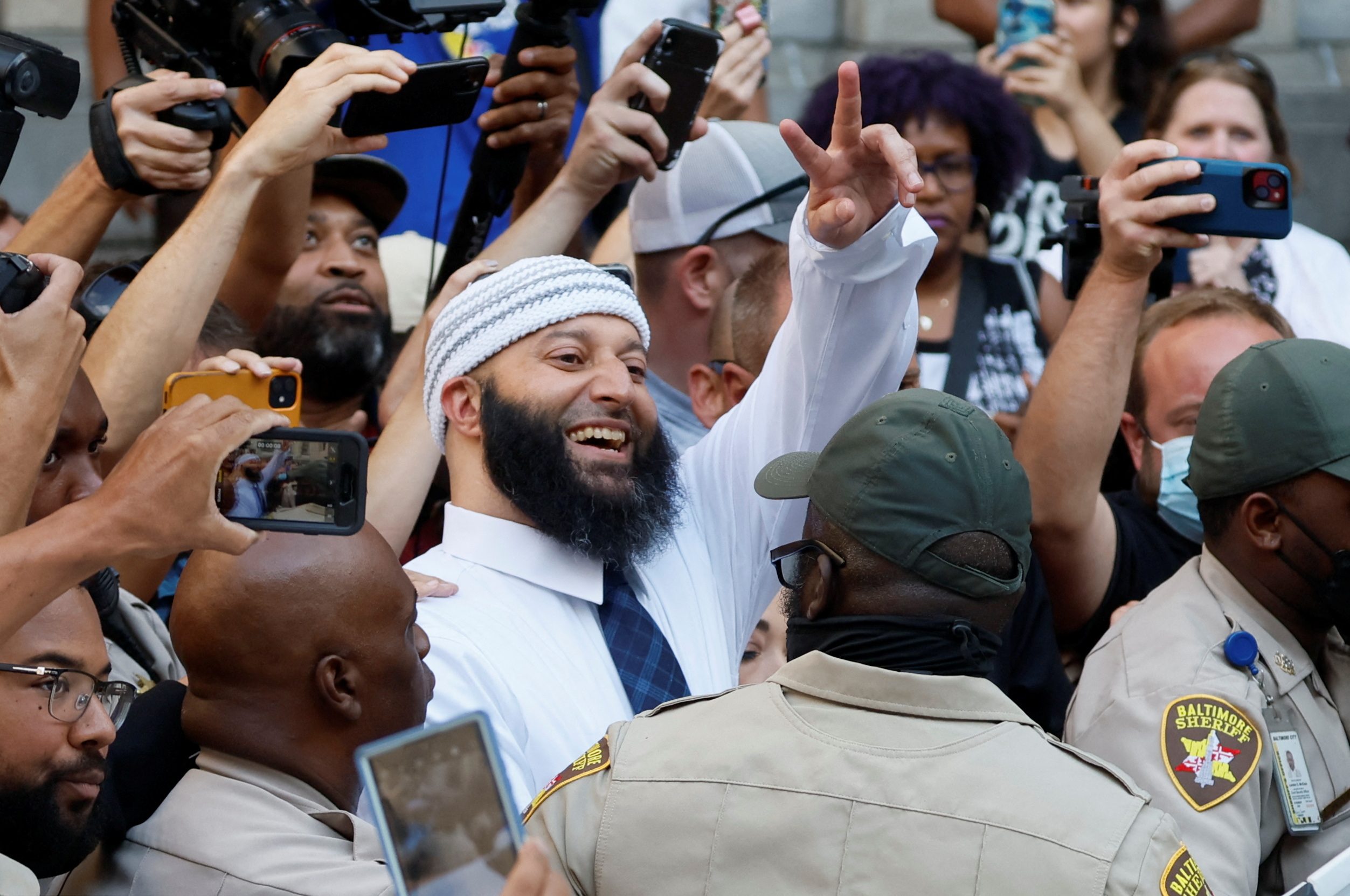 PHOTO: Adnan Syed, whose case was chronicled in the hit podcast "Serial," smiles and waves as he leaves the courthouse after a judge overturned Syed's 2000 conviction and ordered a new trial at the Baltimore City Circuit Courthouse, Sept. 19, 2022