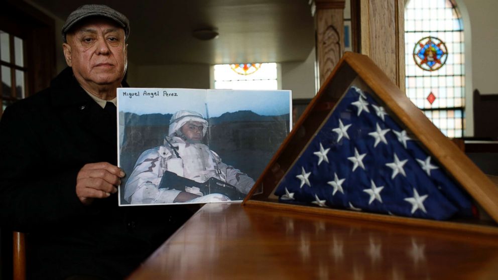 PHOTO: Miguel Perez holds a photo of his son Miguel Perez Jr., April 4, 2017, in Chicago. Perez Jr., an Army veteran is facing deportation after serving seven years in a state penitentiary on a drug charge. 