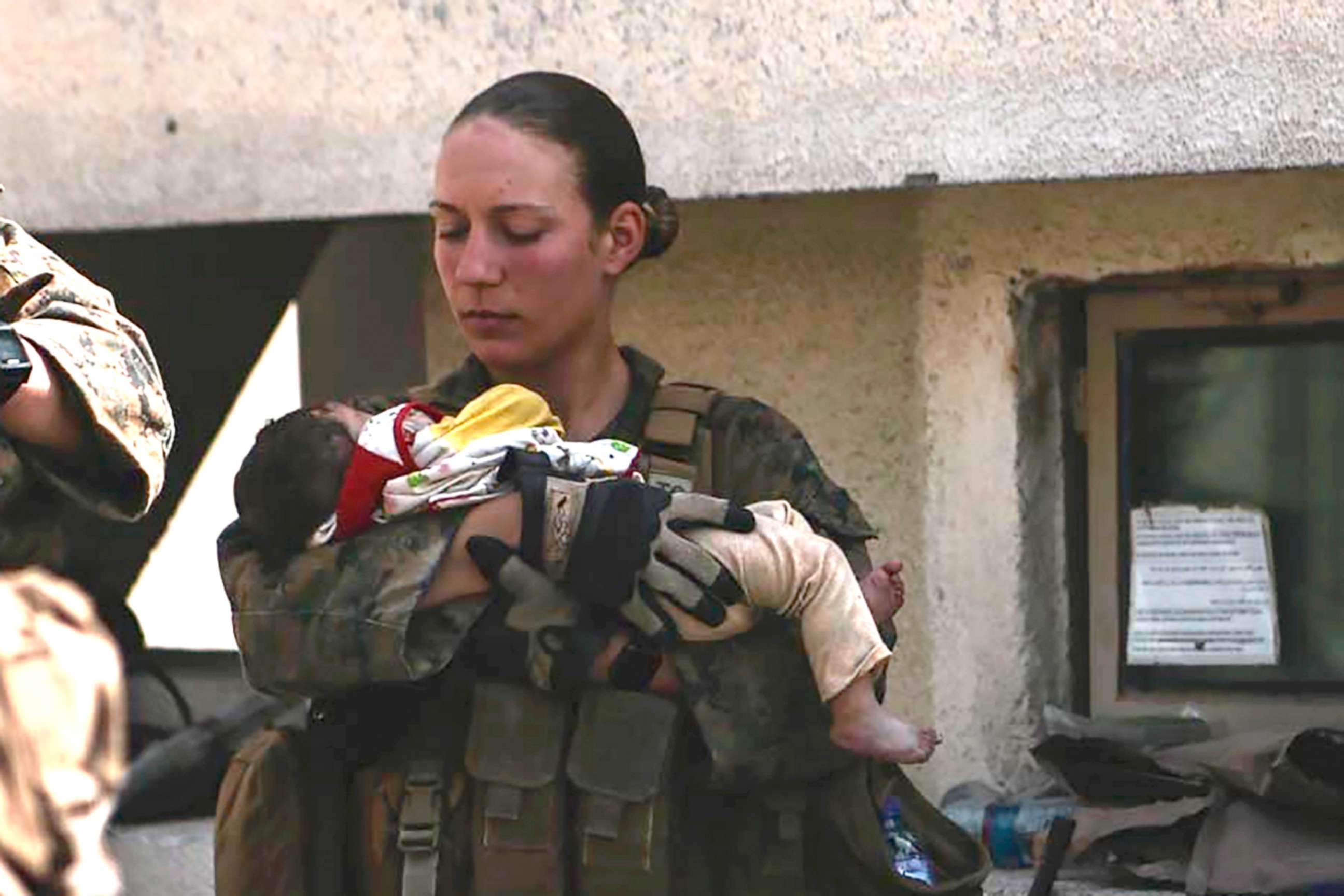 PHOTO: This undated photo provided by U.S. Department of Defense twitter page posted Aug. 20, 2021 shows Sgt. Nicole Gee holding a baby at Hamid Karzai International Airport in Kabul, Afghanistan.  