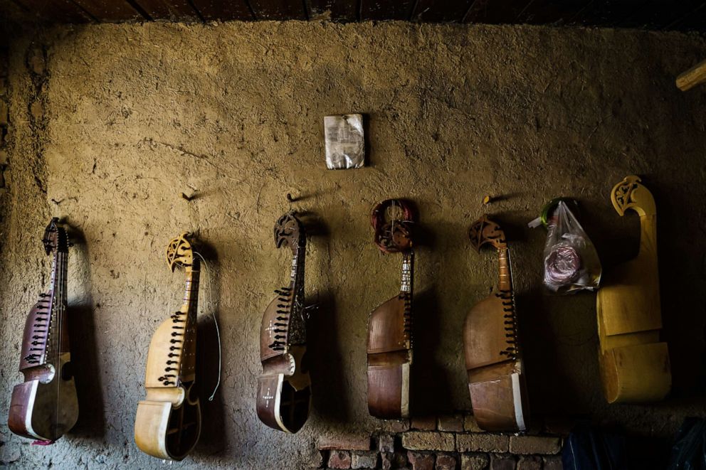 PHOTO: A row of traditional Afghan instruments hang on a wall in a workshop in Kabul, Afghanistan, April 29, 2021.