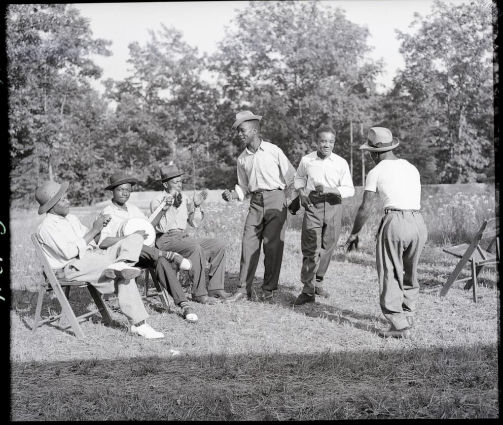 PHOTO: In this undated file photo, a group of African American men are seen singing and dancing on grass.