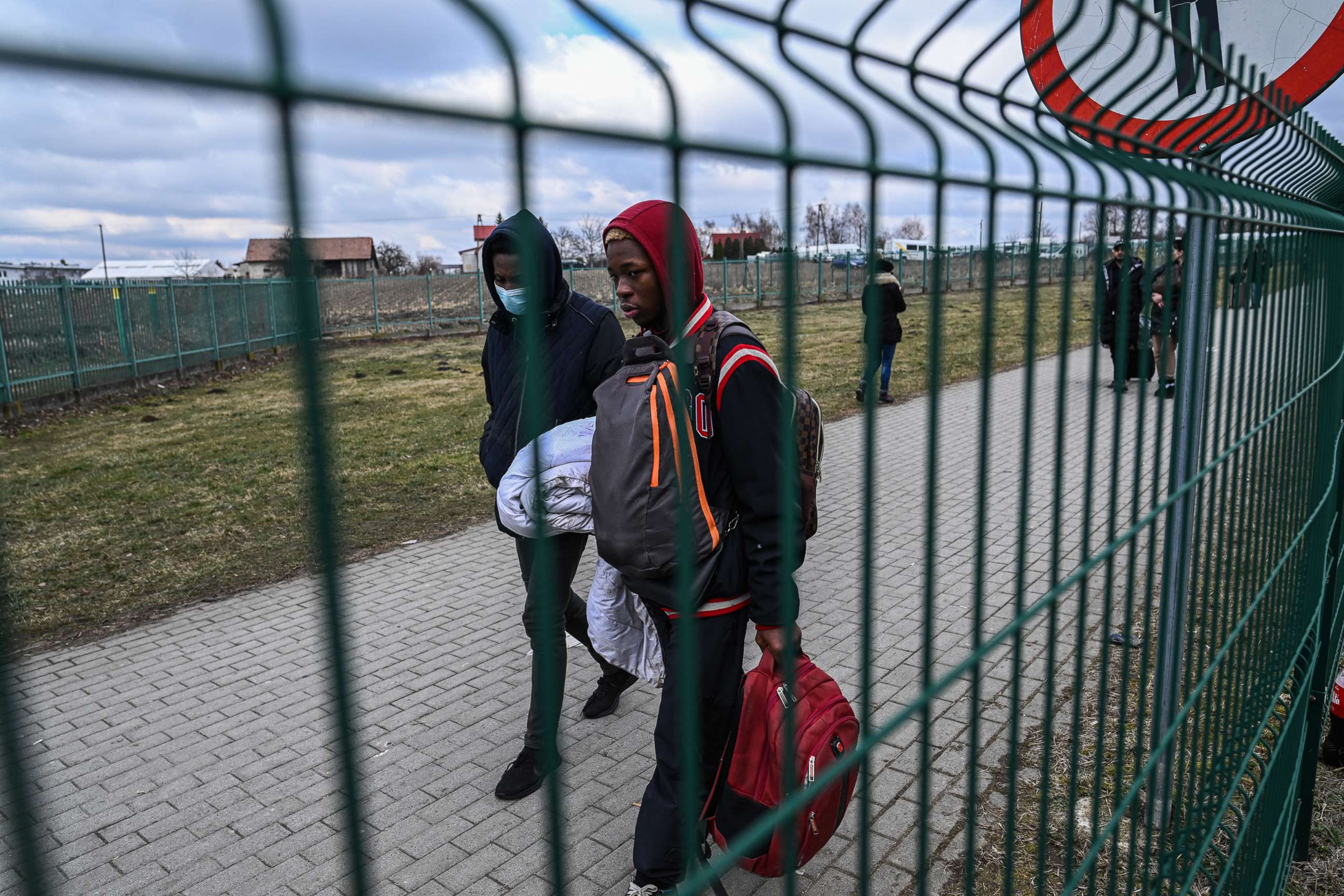 PHOTO: People from the Middle East and Africa carry bags as they arrive at the Polish Ukrainian border crossing on Feb. 28, 2022, in Medyka, Poland.