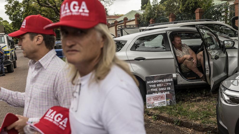 PHOTO: A man wears a Make Afrikaners Great Again cap in reference to the American MAGA as white South Africans supporting President Donald Trump in front of the U.S. Embassy in Pretoria, Feb. 15, 2025.