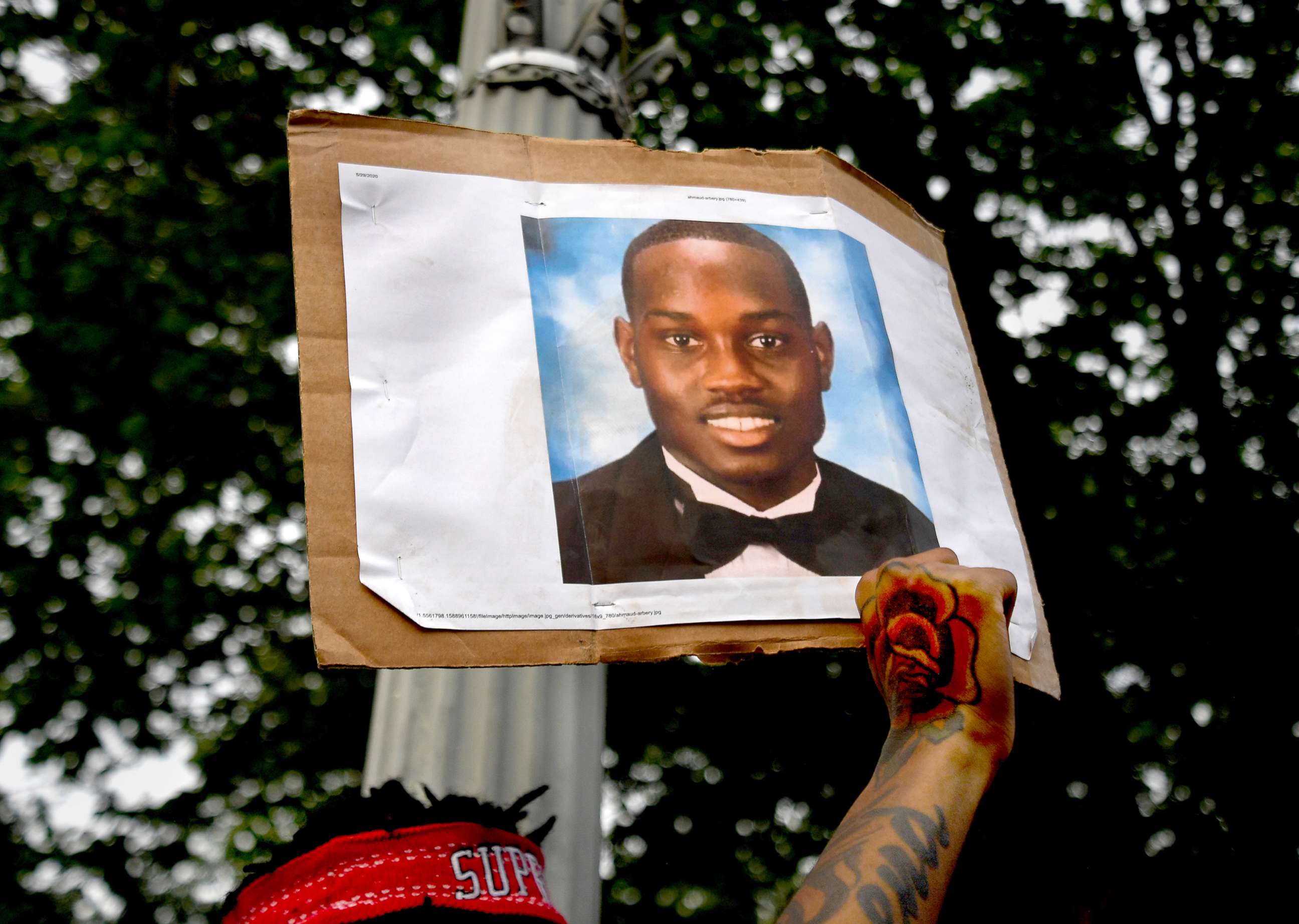 PHOTO: In this May 29, 2020, file photo, a protestor holds up a photo of Ahmaud Arbery at a rally in Washington.