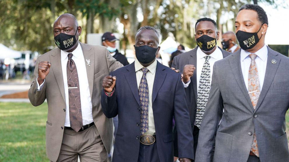 PHOTO: Attorney Ben Crump, left, and Marcus Arbery Sr., the father of Ahmaud Arbery, second from left, arrive at the Glynn County Courthouse as jury selection begins for the trial of the shooting death of Ahmaud Arbery on Oct. 18, 2021, in Brunswick, Ga.