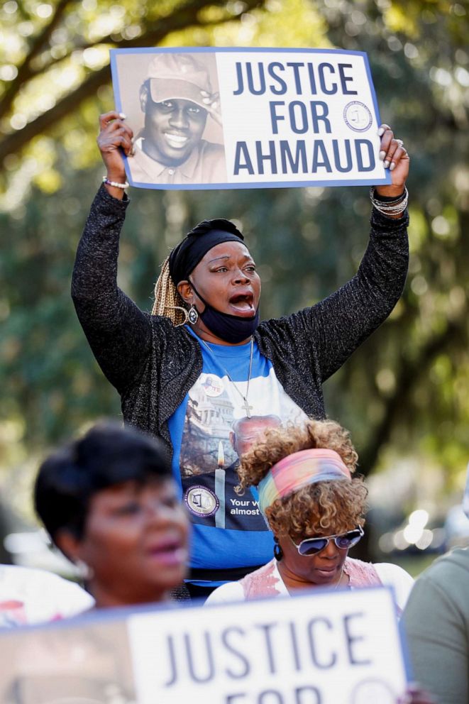 PHOTO: Ruthie Freeman of Milwaukee holds a sign outside the Glynn County Courthouse, where jury selection in Ahmaud Arbery's murder trial begins today, in Brunswick, Georgia, Oct. 18, 2021.