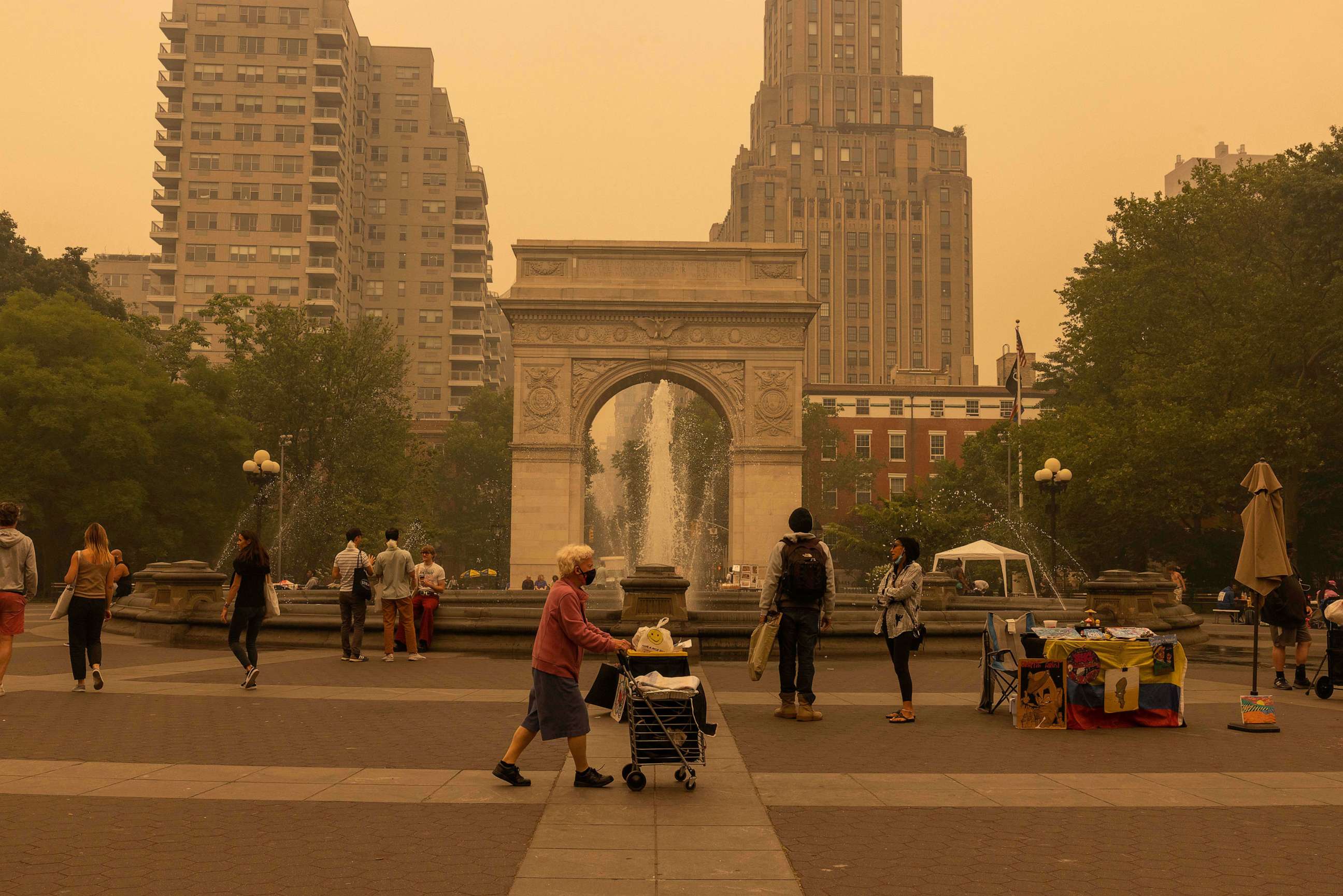 PHOTO: Pedestrians are seen walking in Washington Square Park as smoke from Canada wildfires blankets New York, June 7, 2023.