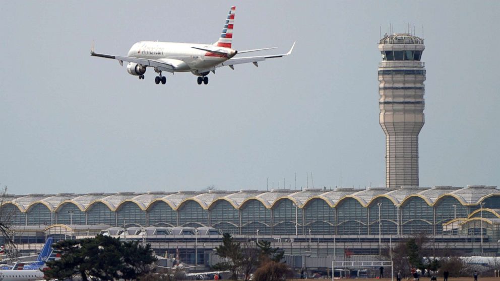 PHOTO: In this Jan. 12, 2019, file photo, an airplane flies past the tower where air traffic controllers work at Reagan National Airport in Washington, D.C.
