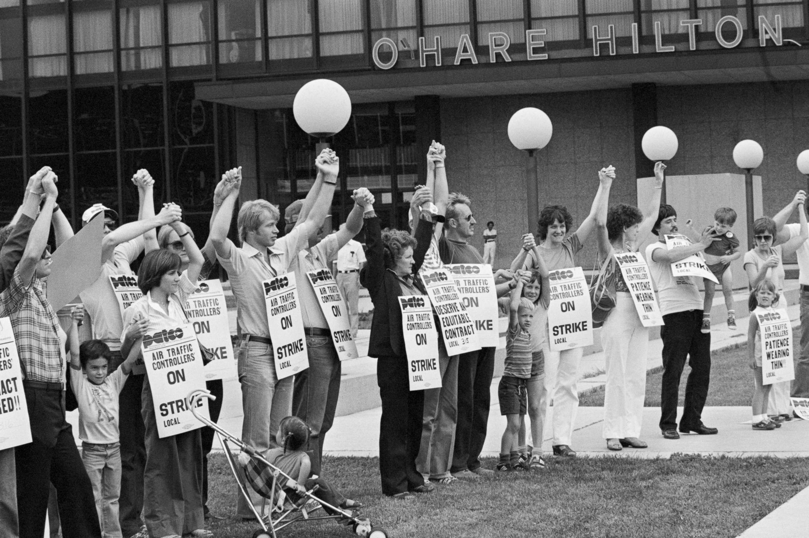 PHOTO: Members of PATCO, the air traffic controllers union, hold hands and raise their arms as their deadline to return to work passes.