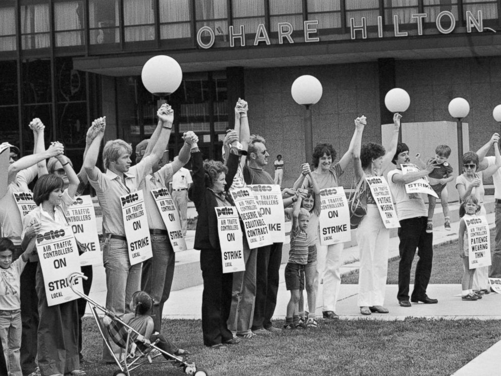 PHOTO: Members of PATCO, the air traffic controllers union, hold hands and raise their arms as their deadline to return to work passes.