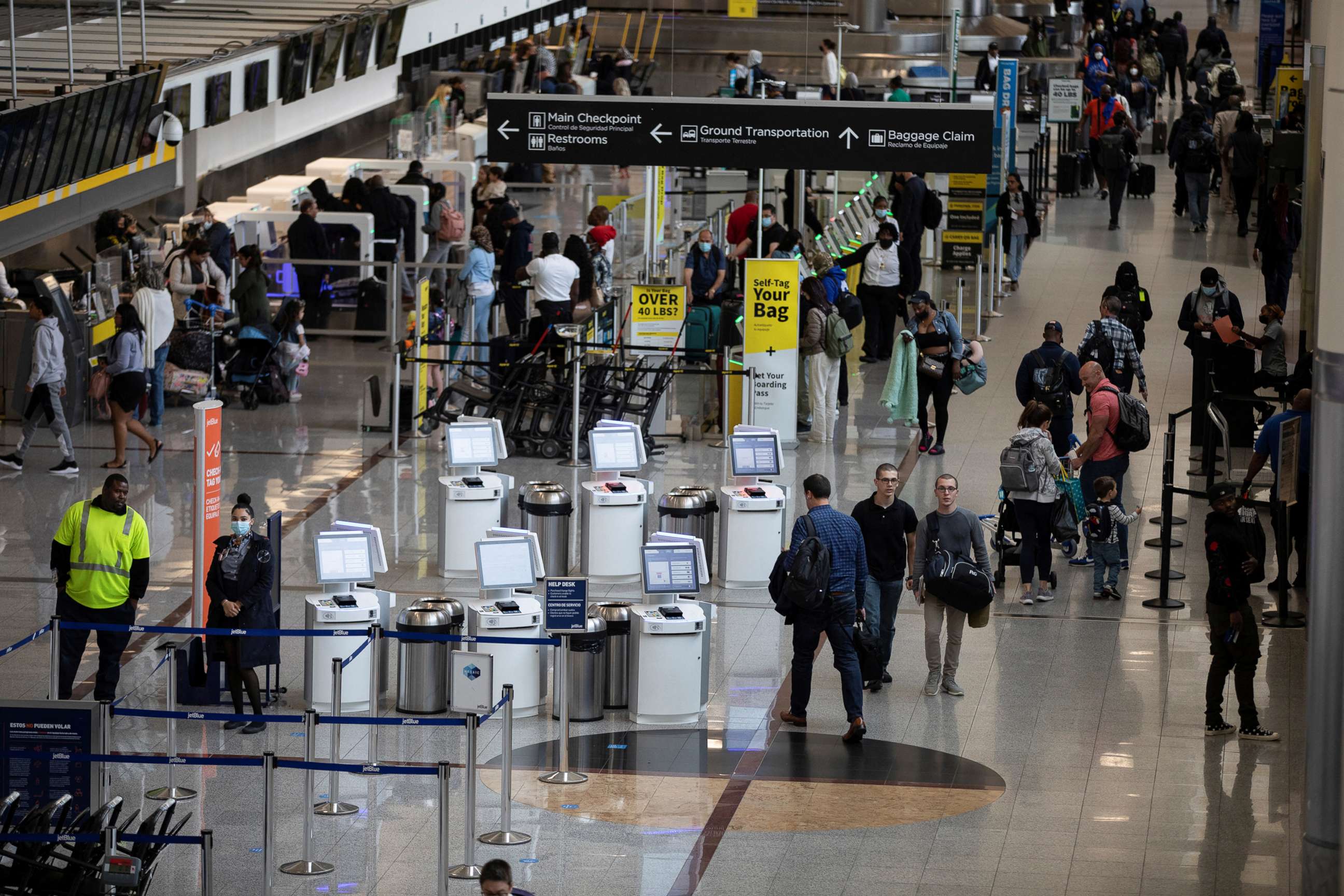 PHOTO: Travelers with and without face masks navigate through the domestic terminal of the Hartsfield-Jackson Atlanta International Airport in Atlanta, April 19, 2022.  