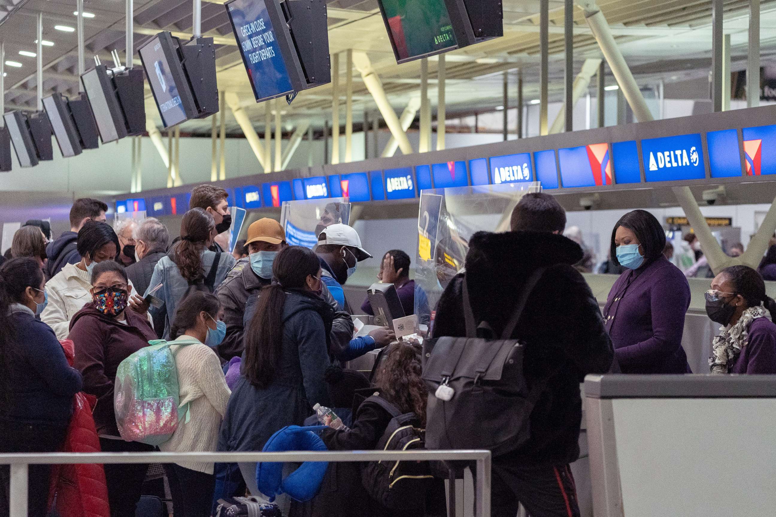 PHOTO: Travelers check in at John F. Kennedy International Airport during the spread of the Omicron coronavirus variant in Queens, New York, Dec. 26, 2021.