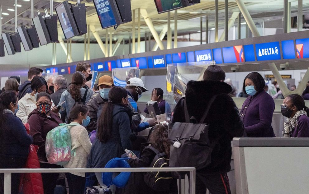 PHOTO: Travelers check in at John F. Kennedy International Airport during the spread of the Omicron coronavirus variant in Queens, New York, Dec. 26, 2021.