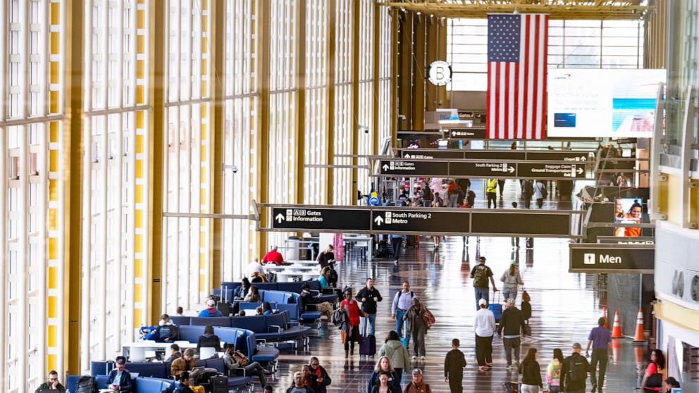 PHOTO: In this March 30, 2026, file photo, travelers walk on the main concourse of Terminal 2 at Ronald Reagan International Airport in Washington, D.C.