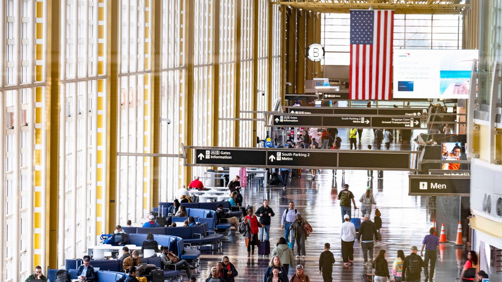 PHOTO: In this March 30, 2026, file photo, travelers walk on the main concourse of Terminal 2 at Ronald Reagan International Airport in Washington, D.C.